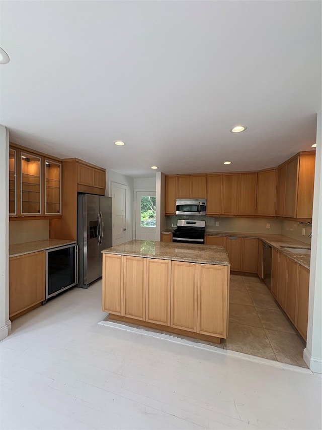 165 Roses Grove Rd, Water Mill, NY 11976 - kitchen with stainless steel appliances, a kitchen island, recessed lighting, glass insert cabinets, and beverage cooler