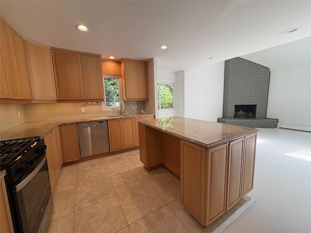 165 Roses Grove Rd, Water Mill, NY 11976 - kitchen featuring dishwasher, range with gas stovetop, a brick fireplace, open floor plan, and a kitchen island