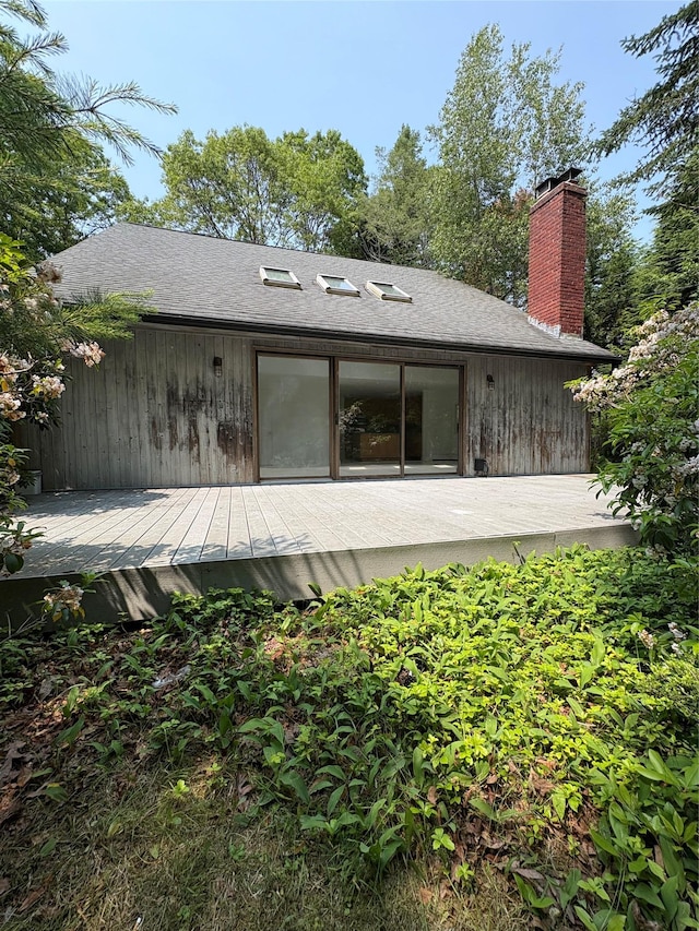 165 Roses Grove Rd, Water Mill, NY 11976 - rear view of house featuring a wooden deck, a chimney, and roof with shingles