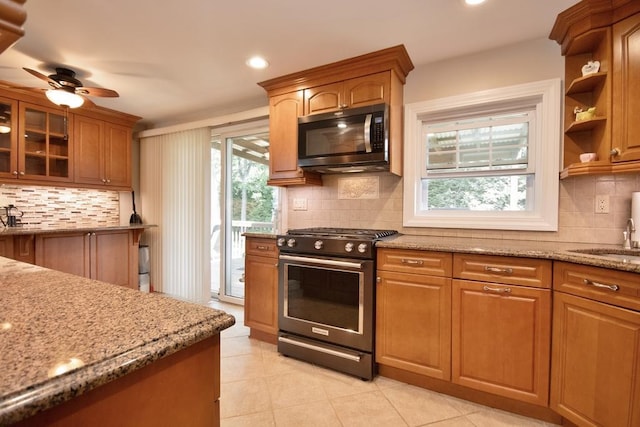 2 Short Hill Rd, New City, NY 10956 - kitchen featuring range with gas cooktop, decorative backsplash, light stone countertops, a ceiling fan, and light tile patterned flooring