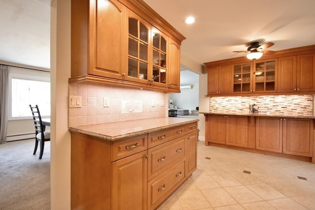 2 Short Hill Rd, New City, NY 10956 - kitchen with baseboard heating, backsplash, glass insert cabinets, and light stone counters