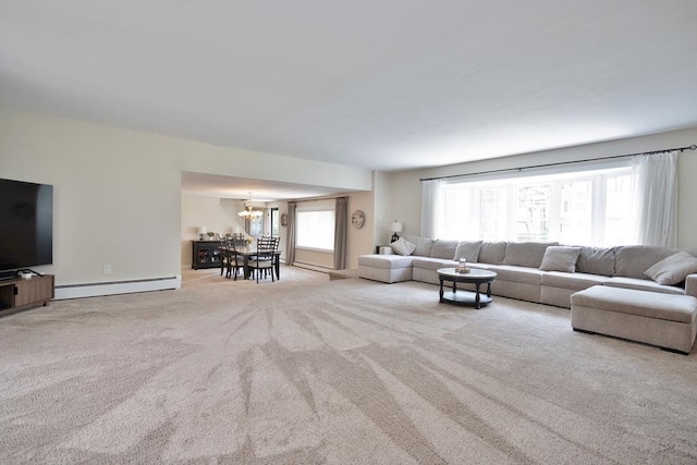 2 Short Hill Rd, New City, NY 10956 - living area featuring a baseboard heating unit, carpet floors, plenty of natural light, and a chandelier