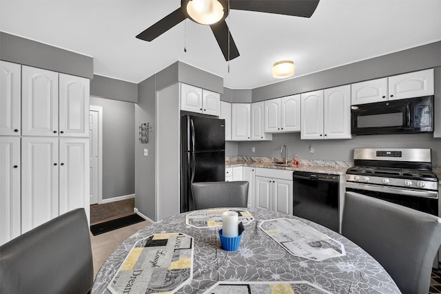 86 Demarest Ave Unit 1, West Nyack, NY 10994 - kitchen with black appliances, ceiling fan, and white cabinets