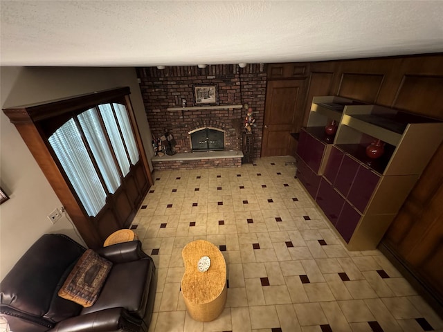 28 Jansen St, Staten Island, NY 10312 - unfurnished living room featuring a textured ceiling, light floors, and a brick fireplace