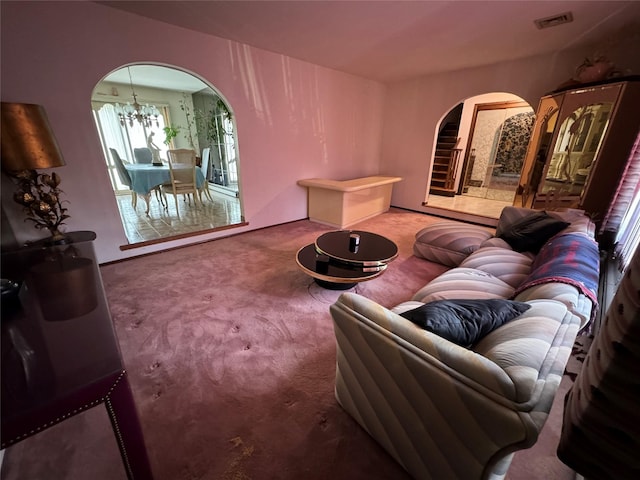 28 Jansen St, Staten Island, NY 10312 - carpeted living room featuring arched walkways and a chandelier