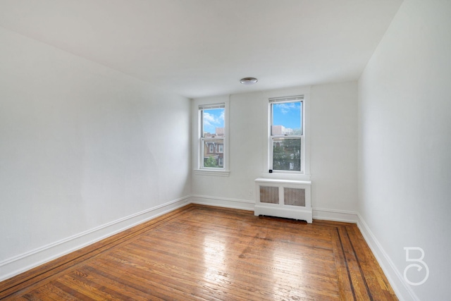 27-12 Ditmars Blvd, Astoria, NY 11105 - spare room featuring hardwood / wood-style floors and radiator