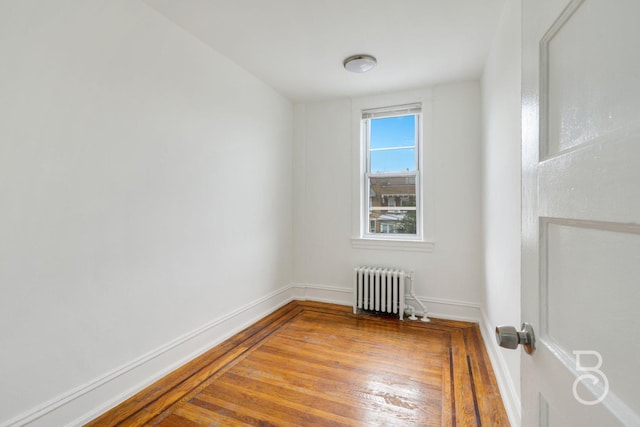 27-12 Ditmars Blvd, Astoria, NY 11105 - spare room with radiator and hardwood / wood-style flooring