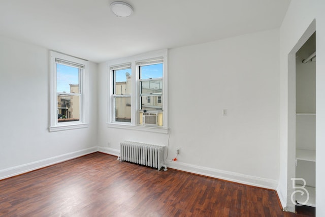 27-12 Ditmars Blvd, Astoria, NY 11105 - empty room with radiator, wood finished floors, and cooling unit