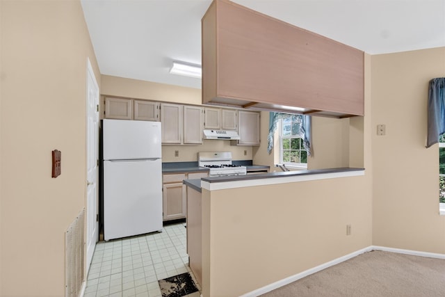 307 Gazebo Ct, New Windsor, NY 12553 - kitchen featuring white appliances, under cabinet range hood, a peninsula, dark countertops, and light tile patterned flooring