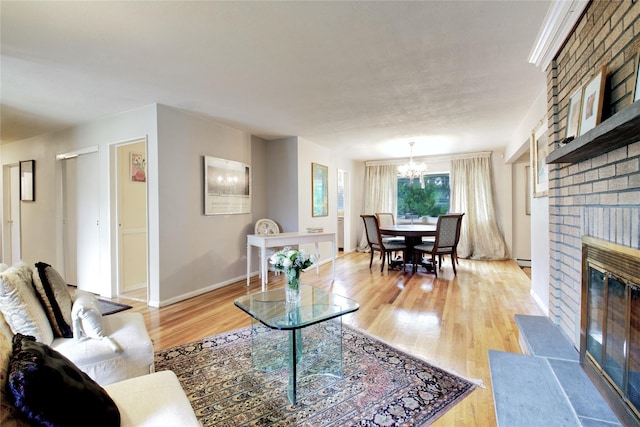 59 Russell Rd, Garden City, NY 11530 - living room with a chandelier, light wood-style floors, and a brick fireplace