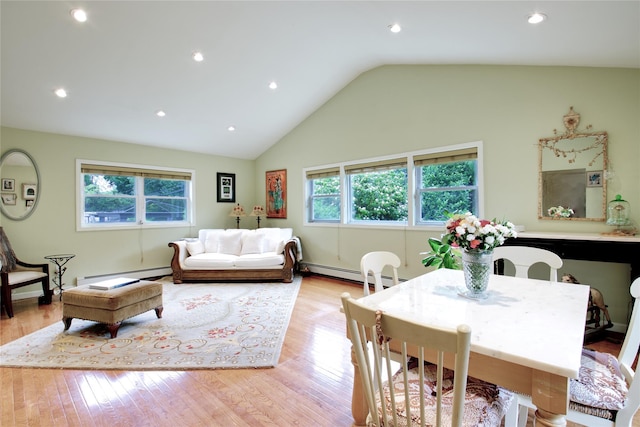 59 Russell Rd, Garden City, NY 11530 - dining area with baseboard heating, a baseboard radiator, plenty of natural light, light wood-type flooring, and lofted ceiling