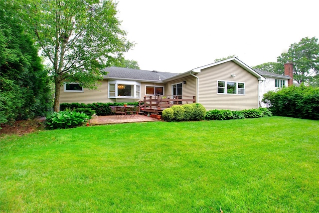 59 Russell Rd, Garden City, NY 11530 - back of house featuring a deck, a lawn, and a patio