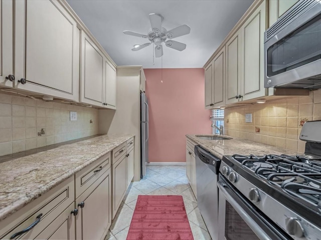 811 Palmer Rd Unit 2A, Bronxville, NY 10708 - kitchen with stainless steel appliances, a ceiling fan, cream cabinetry, and light stone counters