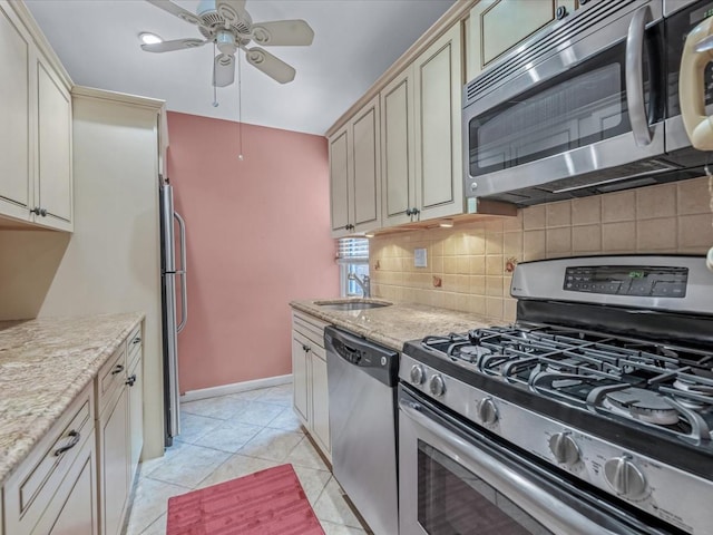 811 Palmer Rd Unit 2A, Bronxville, NY 10708 - kitchen featuring appliances with stainless steel finishes, tasteful backsplash, a ceiling fan, cream cabinets, and light stone countertops