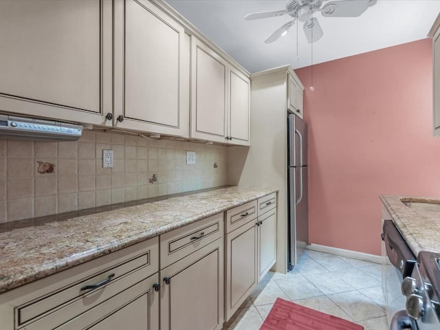811 Palmer Rd Unit 2A, Bronxville, NY 10708 - kitchen with ceiling fan, backsplash, light stone countertops, freestanding refrigerator, and light tile patterned floors