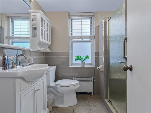 811 Palmer Rd Unit 2A, Bronxville, NY 10708 - bathroom with radiator heating unit, vanity, plenty of natural light, a stall shower, and tile walls
