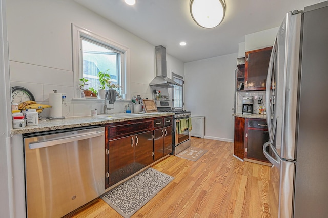 202 Roosevelt Ave, Valley Stream, NY 11581 - kitchen with appliances with stainless steel finishes, wall chimney exhaust hood, light wood-style floors, recessed lighting, and backsplash