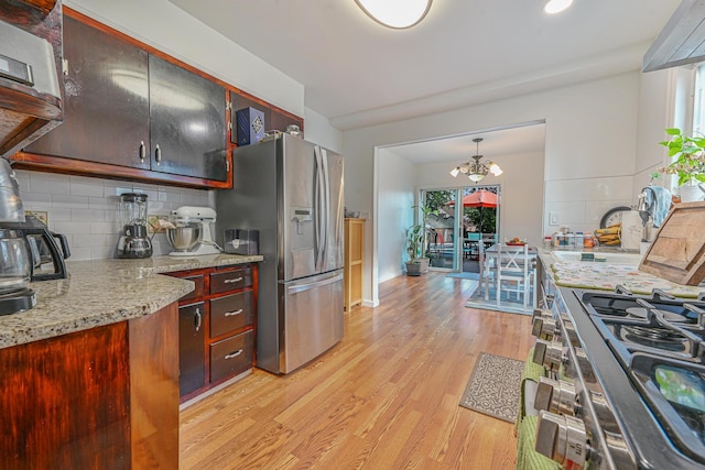 202 Roosevelt Ave, Valley Stream, NY 11581 - kitchen featuring stainless steel refrigerator with ice dispenser, light wood finished floors, decorative backsplash, a chandelier, and stove