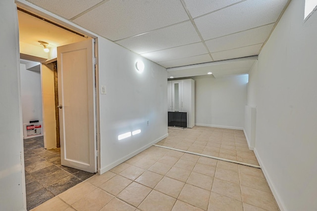 202 Roosevelt Ave, Valley Stream, NY 11581 - tiled spare room featuring a drop ceiling and baseboards