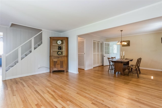 509 Hudson View Rd, Nyack, NY 10960 - dining area featuring stairs, light wood-style flooring, a chandelier, and ornamental molding