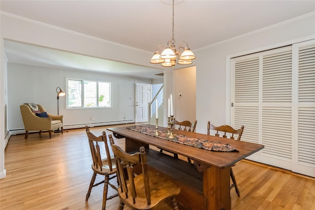 509 Hudson View Rd, Nyack, NY 10960 - dining area featuring a baseboard heating unit, a chandelier, light wood finished floors, and crown molding