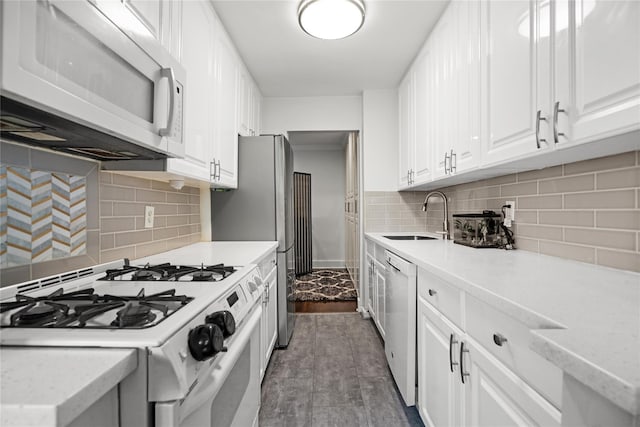 3 Birchwood Ct # 5K, Mineola, NY 11501 - kitchen with white appliances, decorative backsplash, and white cabinets