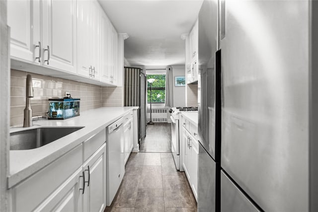 3 Birchwood Ct # 5K, Mineola, NY 11501 - kitchen featuring white appliances, radiator, tasteful backsplash, and white cabinets
