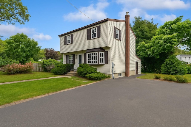 187 Horseblock Rd, Farmingville, NY 11738 - colonial-style house with asphalt driveway and a chimney