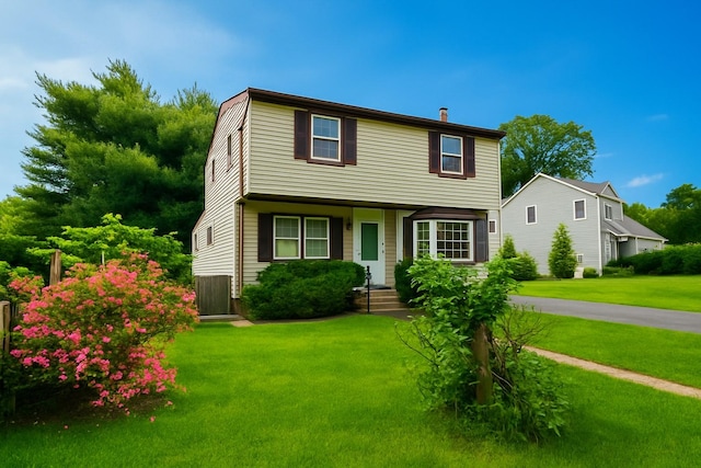 187 Horseblock Rd, Farmingville, NY 11738 - colonial-style house with a front yard and a chimney