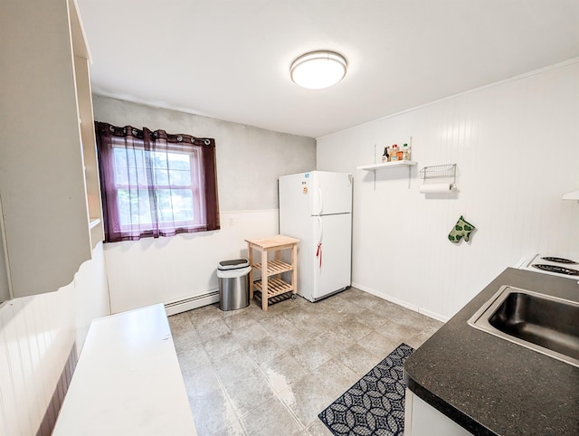 187 Horseblock Rd, Farmingville, NY 11738 - kitchen with freestanding refrigerator, a baseboard radiator, and dark countertops