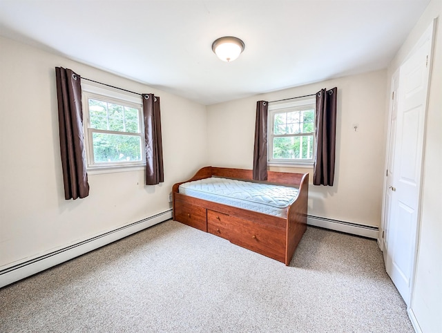 187 Horseblock Rd, Farmingville, NY 11738 - bedroom featuring a baseboard heating unit, multiple windows, and carpet floors