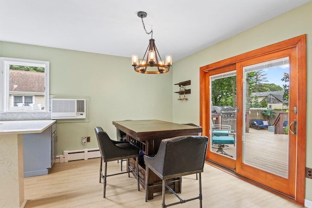 10 Elm Ave, Smithtown, NY 11787 - dining space featuring light wood-style floors, a baseboard radiator, a chandelier, and a wall mounted AC