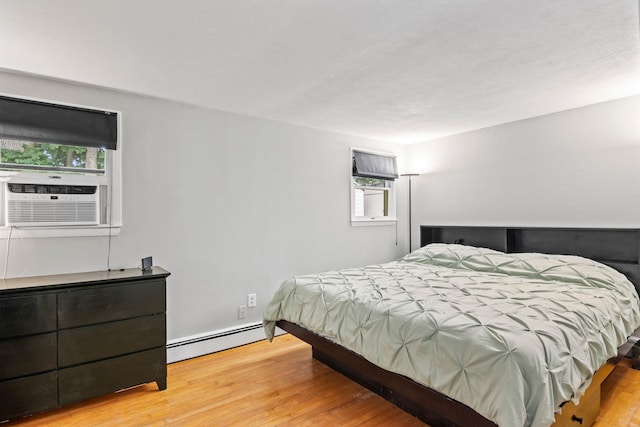 10 Elm Ave, Smithtown, NY 11787 - bedroom with a baseboard heating unit, wood finished floors, and cooling unit