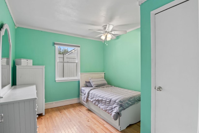 10 Elm Ave, Smithtown, NY 11787 - bedroom featuring a baseboard radiator, ornamental molding, light wood-style floors, and a ceiling fan