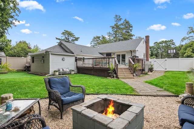 10 Elm Ave, Smithtown, NY 11787 - rear view of house with a fire pit, a wooden deck, a fenced backyard, and a gate