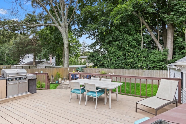 10 Elm Ave, Smithtown, NY 11787 - wooden deck featuring outdoor dining area, a fenced backyard, and grilling area