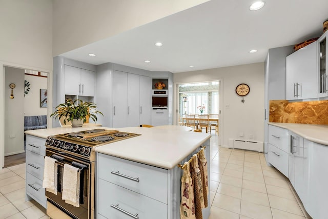 102 Bayview Ave, East Islip, NY 11730 - kitchen featuring electric range oven, recessed lighting, a baseboard heating unit, light countertops, and tasteful backsplash