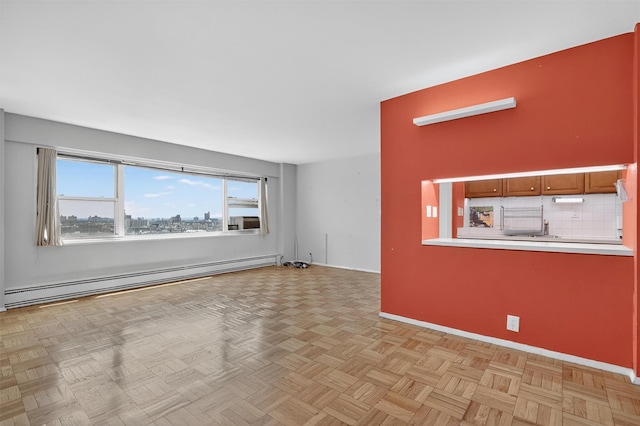 6 Fordham Hill Oval Unit 14B, Bronx, NY 10468 - unfurnished living room with a baseboard heating unit and baseboards