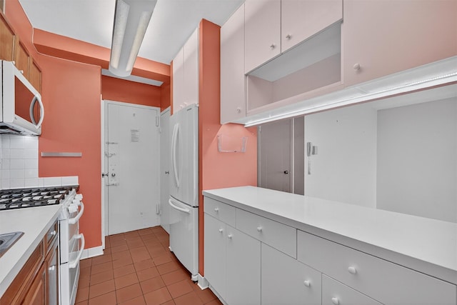 6 Fordham Hill Oval Unit 14B, Bronx, NY 10468 - kitchen featuring white appliances, light countertops, light tile patterned flooring, and decorative backsplash