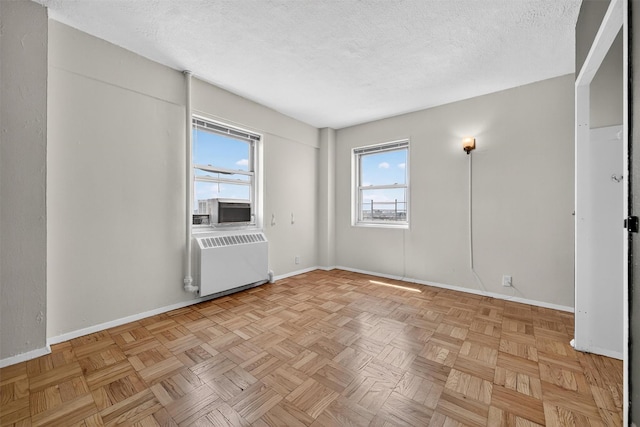 6 Fordham Hill Oval Unit 14B, Bronx, NY 10468 - unfurnished room with radiator heating unit, a textured ceiling, and cooling unit