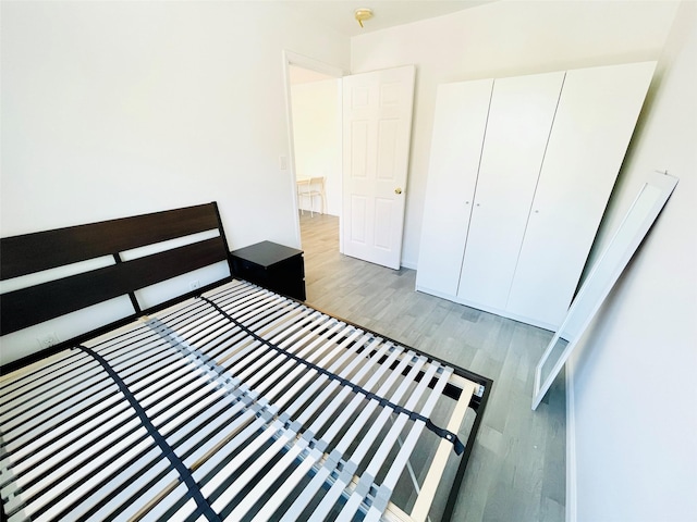 3113 137th St, Flushing, NY 11354 - unfurnished bedroom featuring wood finished floors and a closet