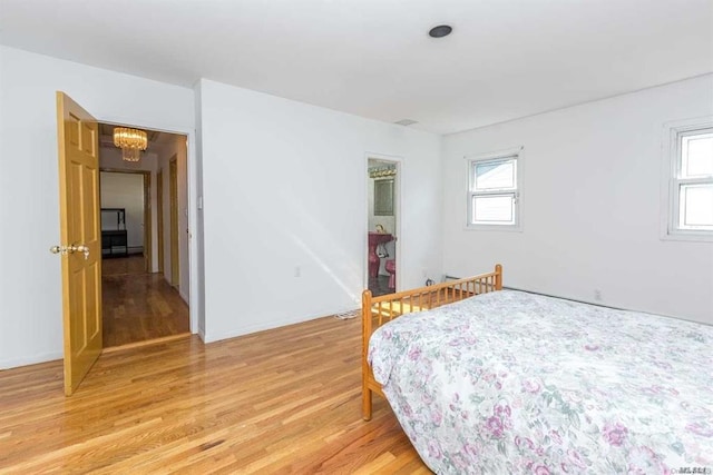 222-60 Birmington Pkwy, Bayside, NY 11364 - bedroom featuring light wood-style flooring and a chandelier