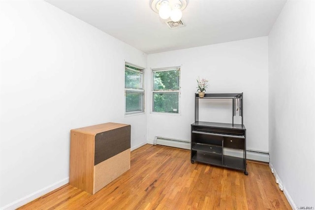 222-60 Birmington Pkwy, Bayside, NY 11364 - unfurnished room featuring a baseboard radiator and wood finished floors