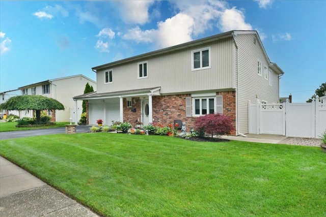 36 Shubert Ln, Bethpage, NY 11714 - view of front of property with a garage, asphalt driveway, brick siding, and a gate