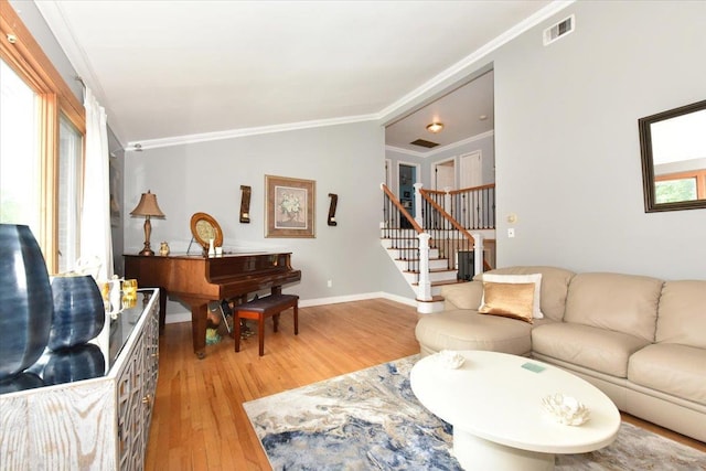36 Shubert Ln, Bethpage, NY 11714 - living area featuring light wood-style floors, ornamental molding, stairs, and vaulted ceiling