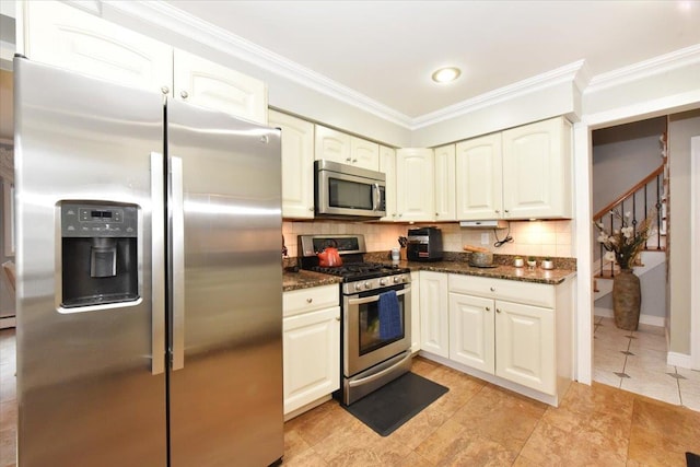 36 Shubert Ln, Bethpage, NY 11714 - kitchen featuring stainless steel appliances, ornamental molding, tasteful backsplash, dark stone countertops, and light tile patterned floors