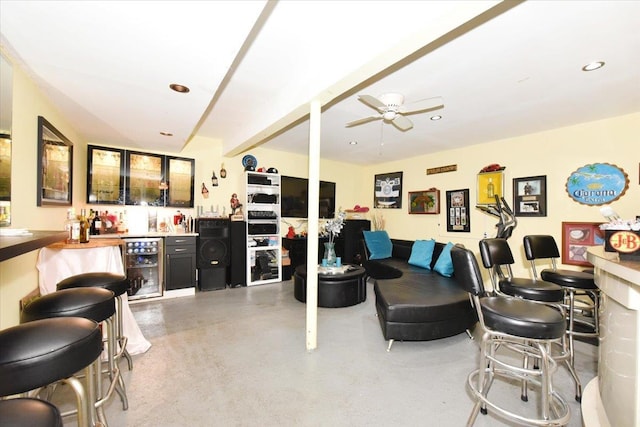 36 Shubert Ln, Bethpage, NY 11714 - living room with beverage cooler, bar, finished concrete flooring, a ceiling fan, and recessed lighting