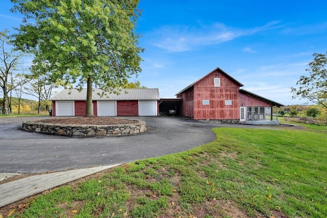 247 Sarah Wells Trl, Campbell Hall, NY 10916 - view of front of property with an outbuilding, a front lawn, asphalt driveway, and a metal roof