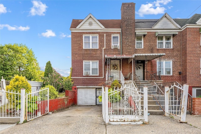 2801 Gunther Ave, Bronx, NY 10469 - townhome / multi-family property with a garage, concrete driveway, brick siding, and a chimney