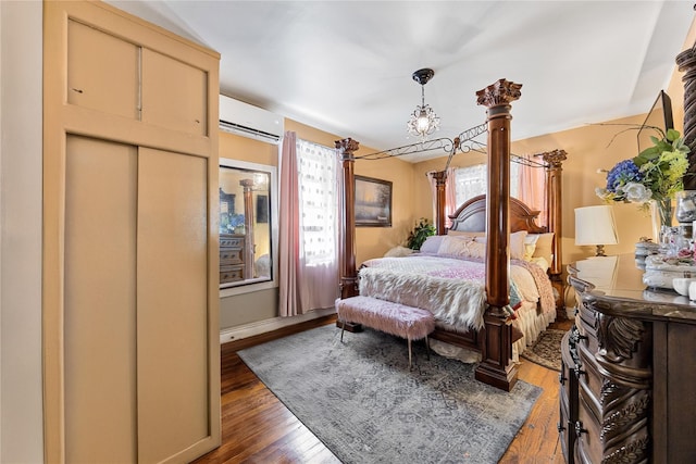 2801 Gunther Ave, Bronx, NY 10469 - bedroom with a wall mounted AC and wood finished floors